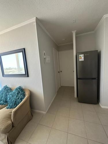 a living room with a couch and a refrigerator at Condominio Río Elqui in La Serena