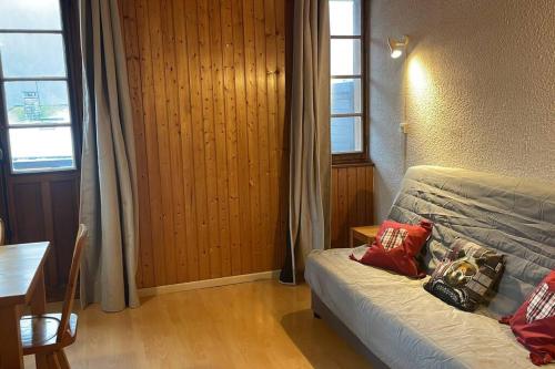 sypialnia z łóżkiem z czerwonymi poduszkami w obiekcie Appartement Cosy idéalement situé w mieście Le Grand-Bornand