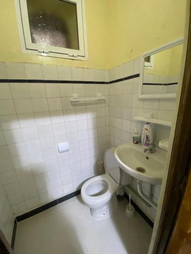 a bathroom with a white toilet and a sink at Private room in the kasbah in Tangier