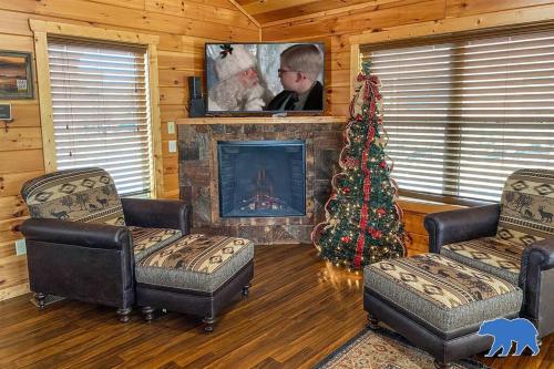 a living room with a christmas tree and a fireplace at Blue Bear Lodge near Dollywood! 1 mile off PKWY Community Pool Hot tub Game Rm in Pigeon Forge