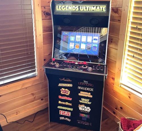 a video game machine with a train on it at Blue Bear Lodge near Dollywood! 1 mile off PKWY Community Pool Hot tub Game Rm in Pigeon Forge