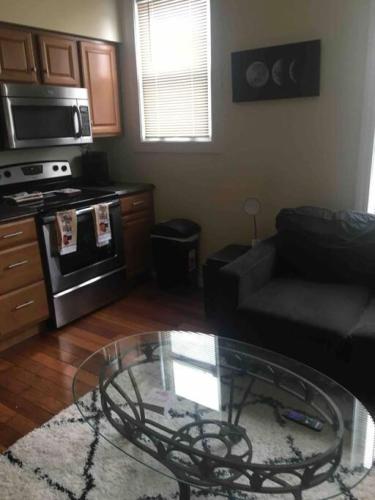 a living room with a couch and a glass table at The couples home in Schenectady