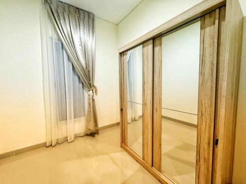 an empty room with a mirror and a window at 4 Bedrooms Big Holiday House with Pool by PlayHouse at Batam Center in Batam Center