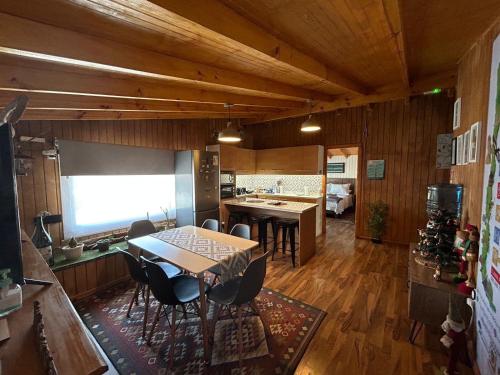 a kitchen with a table and chairs in a room at Hostal Senderos del Sur in Freire