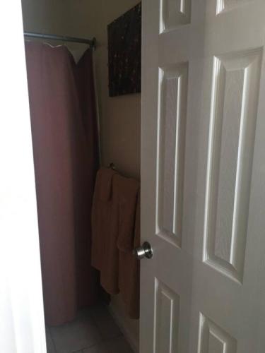 a bathroom door with a shower and a towel at Meet the browns with parking in Schenectady