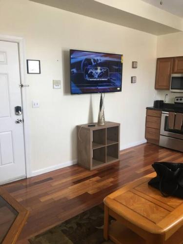a living room with a tv on the wall at Meet the browns with parking in Schenectady