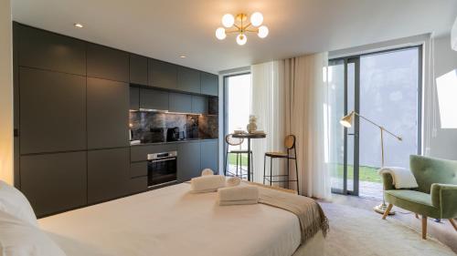 a bedroom with a large bed and a large window at RUAH Apartments by LovelyStay in Vila Nova de Gaia
