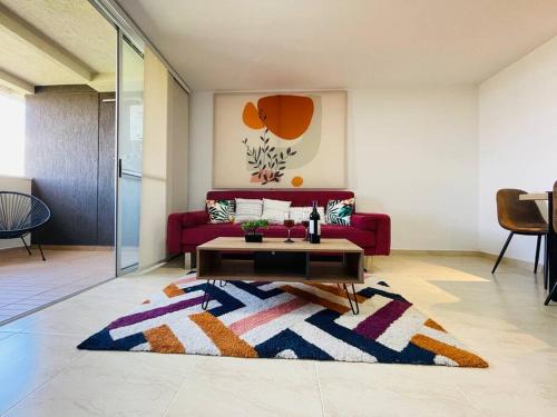 a living room with a red couch and a rug at Stunning view, near airport JMC, fast Wi-Fi in Marinilla