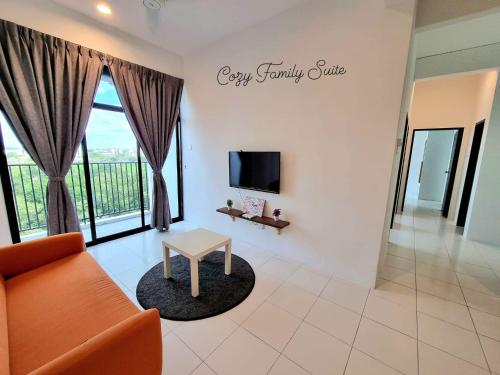 a living room with a couch and a table at Homestay Cozy Family Suite @ Imperio Alor Setar in Alor Setar