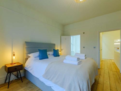 ein Schlafzimmer mit einem großen weißen Bett mit blauen Kissen in der Unterkunft 2 Bed in Broadstairs 89889 in Broadstairs