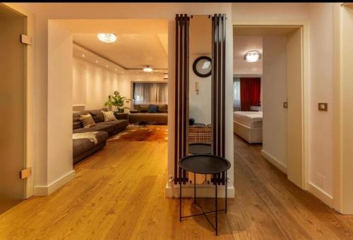 a living room with a mirror and a couch at Downtown Oasis Unirii Apartment in Bucharest