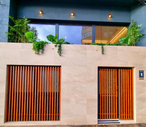two orange doors on the side of a building at Apartamentos Bahía&Arena - Centro in Santander