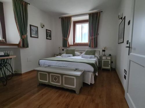 a bedroom with two beds and a window at Hotel Dente Del Gigante in Courmayeur