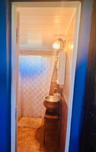 a bathroom with a sink in a small room at CABAÑA LA BOHEMIA in Colonia Hughes