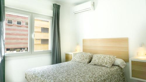 a bedroom with a bed and a window at Juanito Fuengirola Apartment in Fuengirola