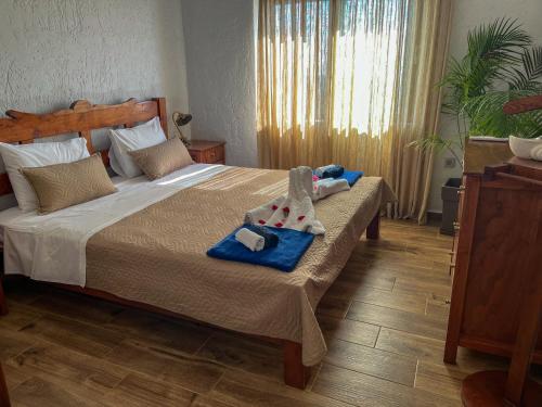a bedroom with a bed with towels on it at Villa Kore Elafonissi in Ãyios FÃ³tios