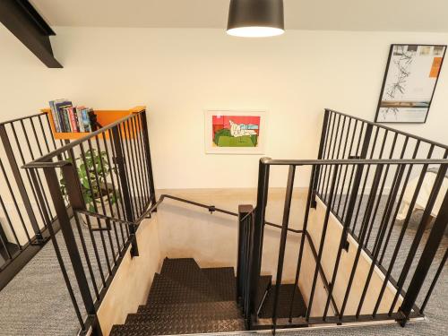 a room with a staircase with a table at The Pump House Forge in Doncaster