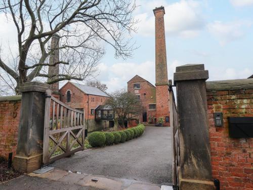 an entrance to an old brick building with a gate at The Pump House Forge in Doncaster