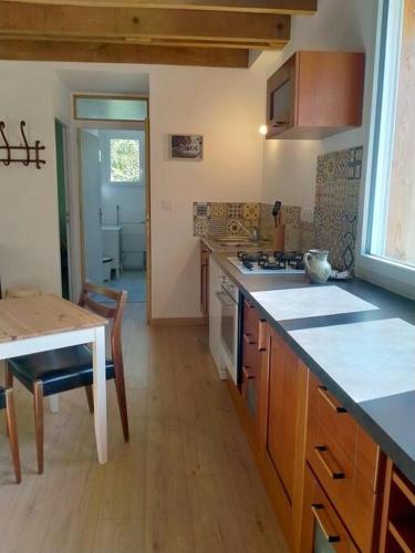 a kitchen with a table and a counter top at Gîte à la ferme in Questembert