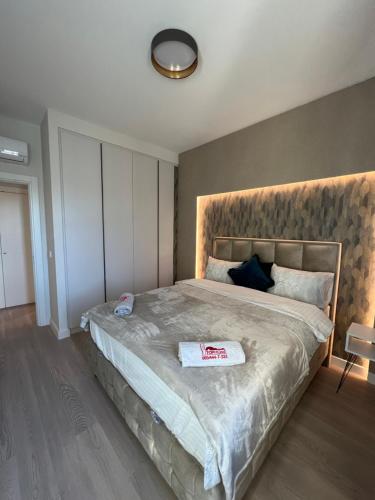 a bedroom with a large bed with a large headboard at BW Libera luxury apartment in Belgrade