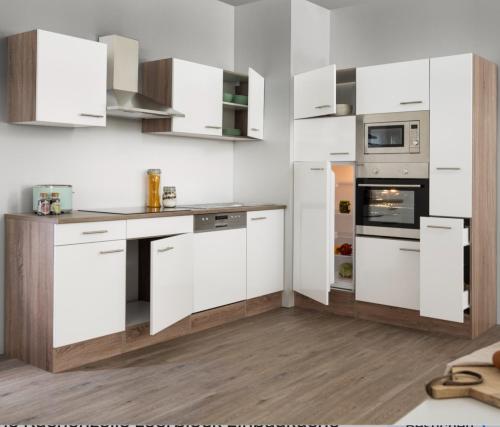 a white kitchen with white cabinets and appliances at ZENTRALO in Aschaffenburg