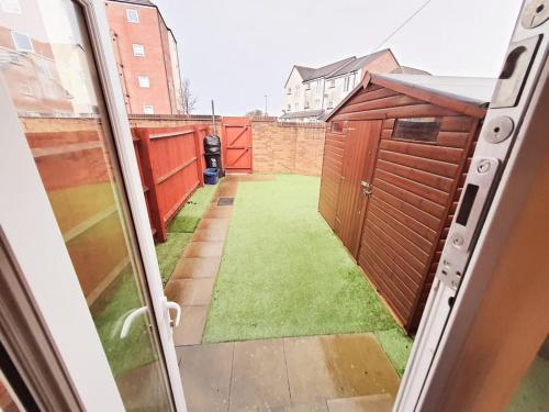 a view from a door of a yard with a grass yard at - Modern 3 Bed in Newport - Close to City Centre - in Newport