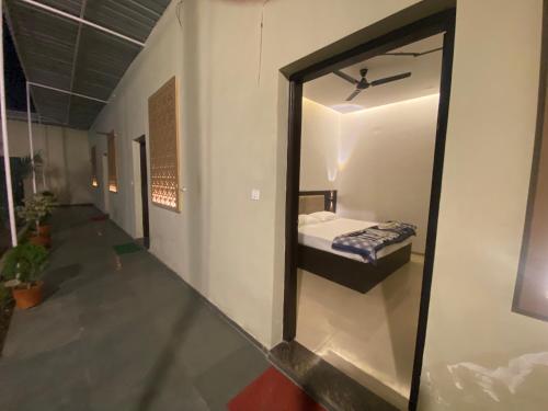 a mirror in a room with a bed in it at Solitaire Gardens Near Airport in Lucknow