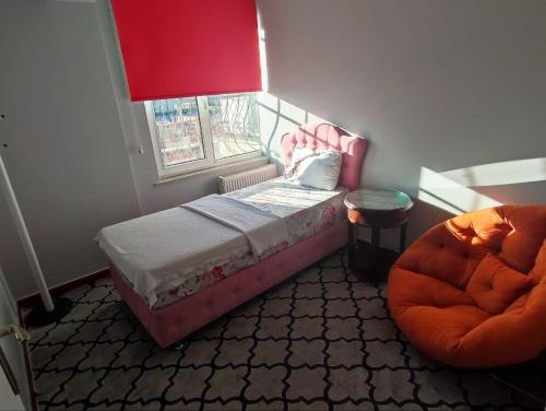 a small bedroom with a bed and a window at Journey's Ease in Istanbul