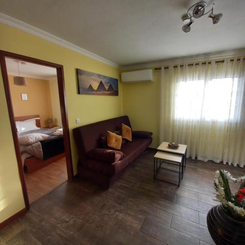 a living room with a couch and a bed at Casa da Fonte in Peso da Régua