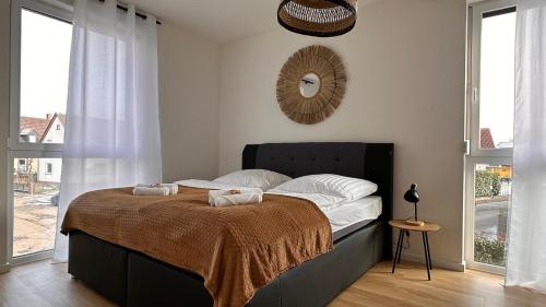 a bedroom with a bed with two pillows on it at AMAO-Grey I 86qm I KingSizeBetten I Netflix I Balkon I Parkplatz I EuropaPark in Rheinhausen