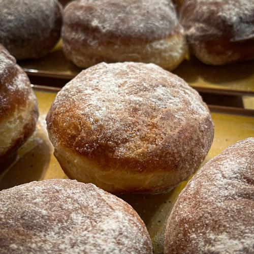 a bunch of sugar covered donuts on a tray at Chalet Deluț in Suceava