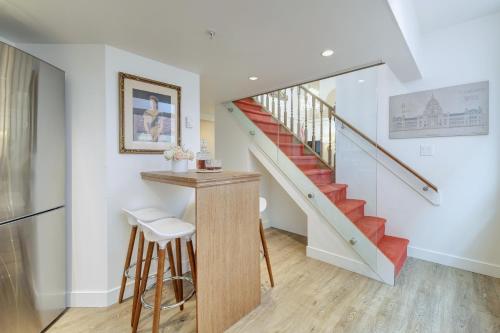a staircase in a home with a table and stool at Victoria's Parliamentary Suite with Private Rooftop Patio & Harbour View in Victoria