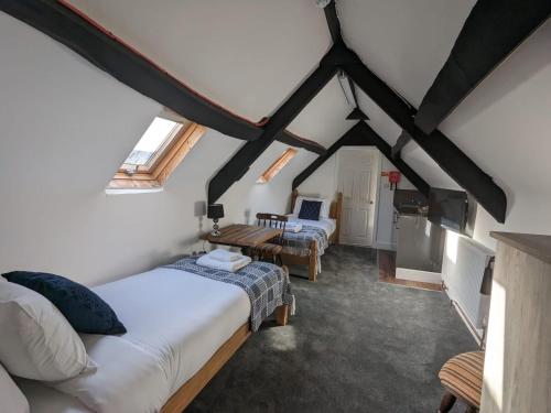 a bedroom with two beds in a attic at The White Lion Hotel, Church Road, Yate BS37 5BG in Yate