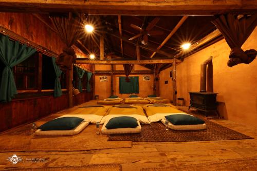 a large bedroom with a large bed with pillows at Dinh Đá H'Mông - Karsterly Rock Lodge in Dồng Văn