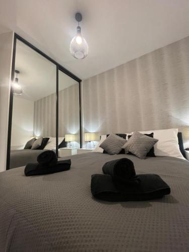 a bedroom with a large bed with two towels on it at ST55 Apartament in Rzeszów