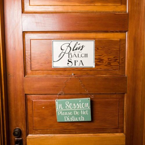 a wooden door with a sign on it at Balch Hotel in Dufur