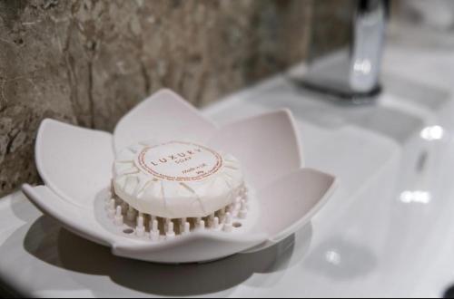 a cake sitting on top of a plate on a table at Anelli Hotel in Southport