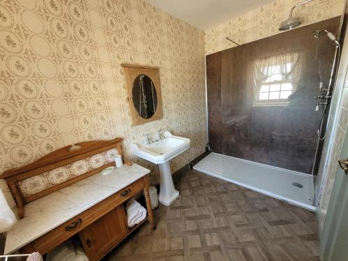 a bathroom with a sink and a shower at Burton Grange Farmhouse Bed and Breakfast in Boroughbridge