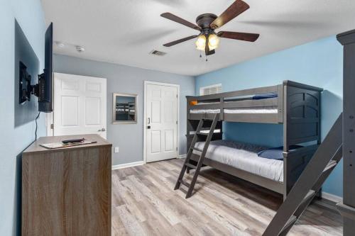 a bedroom with a bunk bed and a ceiling fan at 4 FREE Kayaks for use & short drive to the beach! in Bolivar Peninsula