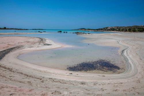 an empty beach with a body of water at Villa Kore Elafonissi in Ãyios FÃ³tios