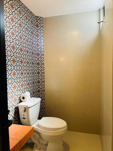 a bathroom with a white toilet in a room at MarySol Las Palmas in Rincon de Guayabitos