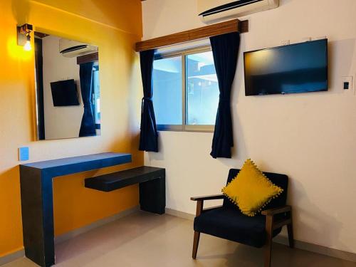 a room with a desk and a chair and a mirror at MarySol Las Palmas in Rincon de Guayabitos