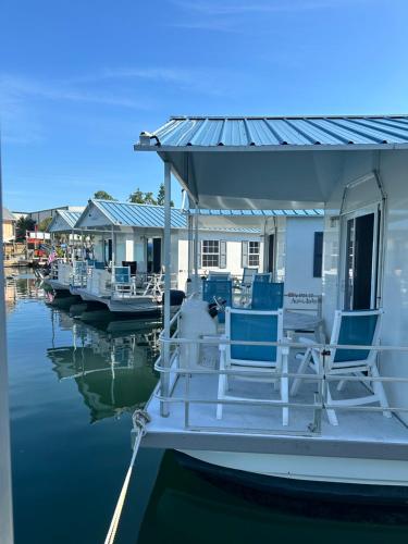 a boat with chairs on a dock in the water at Aqua Lodges At Hurricane Hole Marina in Key West