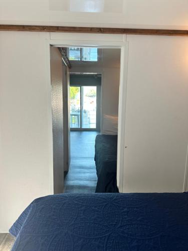a bedroom with a bed and a door to a hallway at Aqua Lodges At Hurricane Hole Marina in Key West
