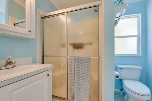 a bathroom with a shower with a toilet and a sink at Tree Top Paradise in Cudjoe Key