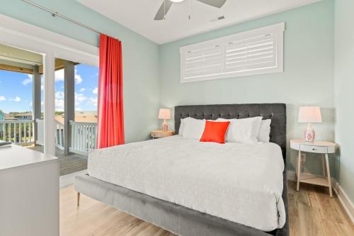 a bedroom with a bed and a balcony at Zensation 14 Bedroom Home by KEES Vacations in Salvo