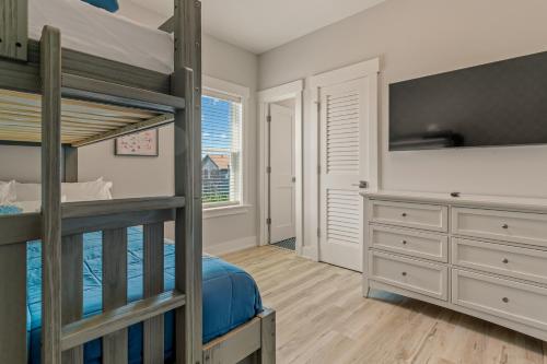 a bedroom with two bunk beds and a desk at Zensation 14 Bedroom Home by KEES Vacations in Salvo