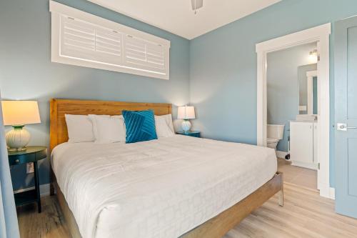 a bedroom with a large bed with blue walls at Zensation 14 Bedroom Home by KEES Vacations in Salvo