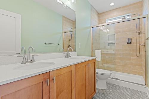 a bathroom with a sink and a toilet and a shower at Zensation 14 Bedroom Home by KEES Vacations in Salvo
