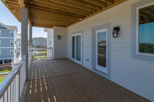 a porch of a home with a wooden deck at Zensation 14 Bedroom Home by KEES Vacations in Salvo